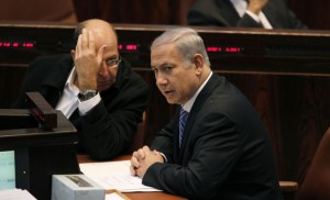 Israel's Prime Minister Netanyahu sits next to Vice Prime Minister Yaalon during a memorial service in Jerusalem