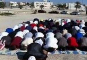 Bahraini people say prayers in mosque debris