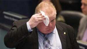 Toronto Mayor Rob Ford wipes his face during council at City Hall in Toronto