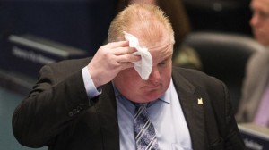 Toronto Mayor Rob Ford wipes his face during council at City Hall in Toronto