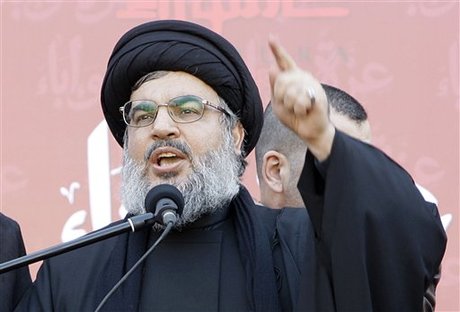 Hezbollah leader Sheik Hassan Nasrallah, speaks to the crowd in a rare public appearance during a rally to mark the Muslim holy day of Ashoura, in the Hezbollah stronghold of south Beirut, Lebanon, on Tuesday Dec. 6, 2011. Sheik Hassan Nasrallah has rarely been seen in public since his Shiite Muslim group battled Israel in a monthlong war in 2006, fearing Israeli assassination. Since then, he has communicated with his followers and gives news conference mostly via satellite link. Ashoura marks the anniversary of the death in the seventh century of the Prophet Muhammad's grandson Imam Hussein. His death in a battle outside of the Iraqi city of Karbala sealed Islam's historical Sunni-Shiite split, which still bedevils the Middle East. Ashoura is one of the holiest days of the Muslim Shiite calendar.  (AP Photo/Bilal Hussein)