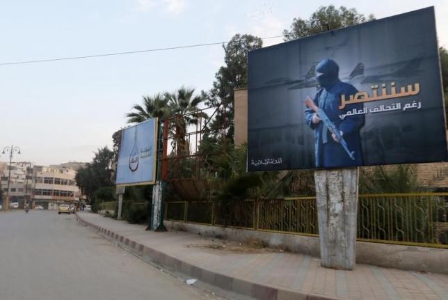 Islamic State billboards are seen along a street in Raqqa, eastern Syria, which is controlled by the Islamic State, October 29, 2014.  REUTERS/Nour Fourat